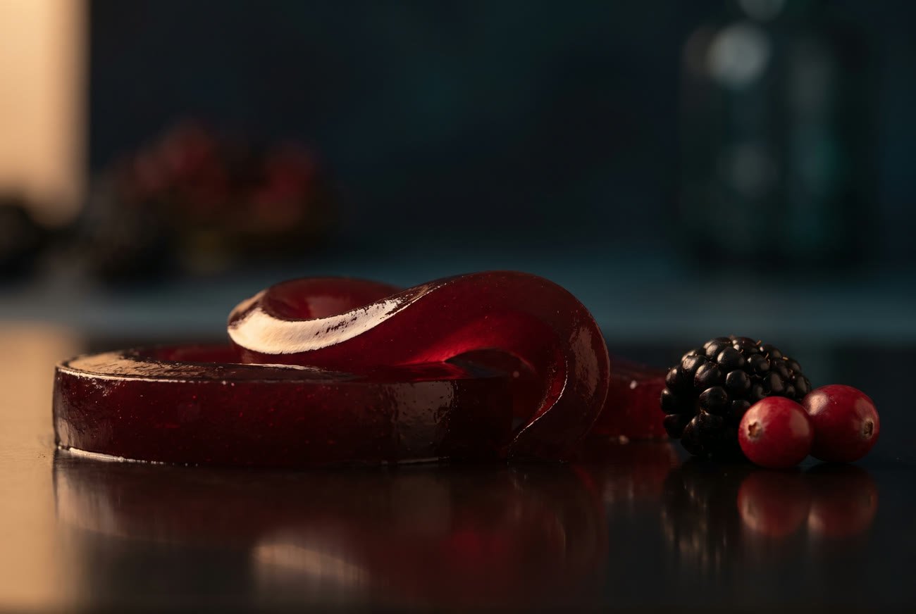 A ribbon of ruby botanical jelly at rest